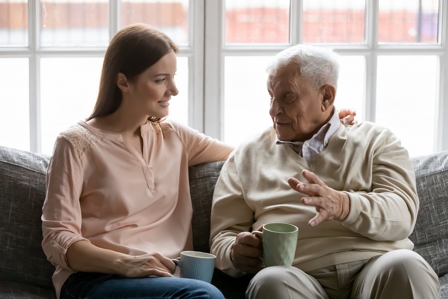 Aging In Place - daughter sitting with elderly father having a conversation