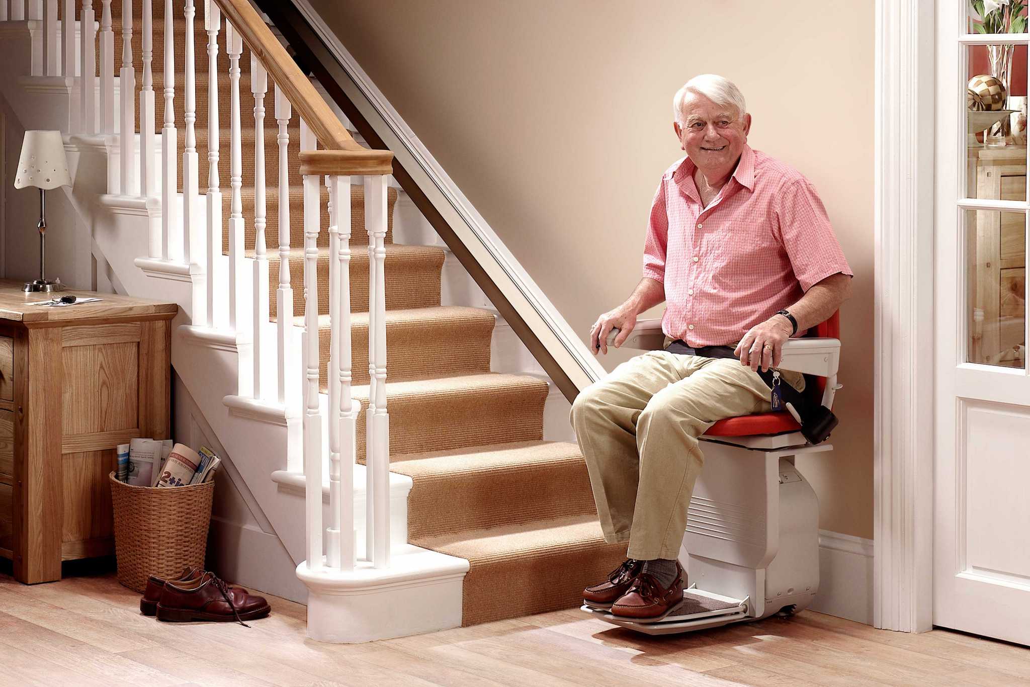 elderly man sitting on stairlift