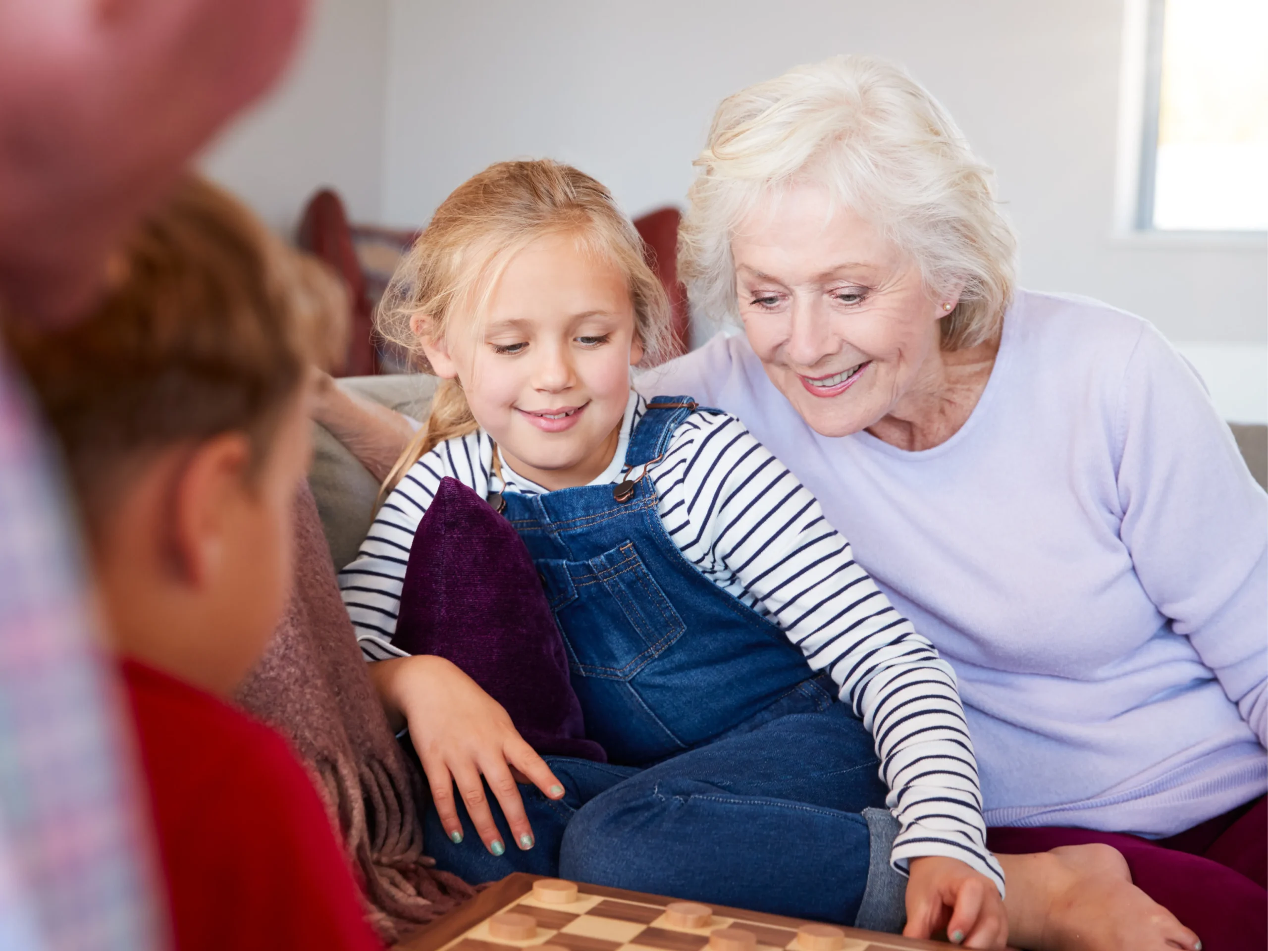 grandparents playing a game with grandkids - making memory games for seniors fun!