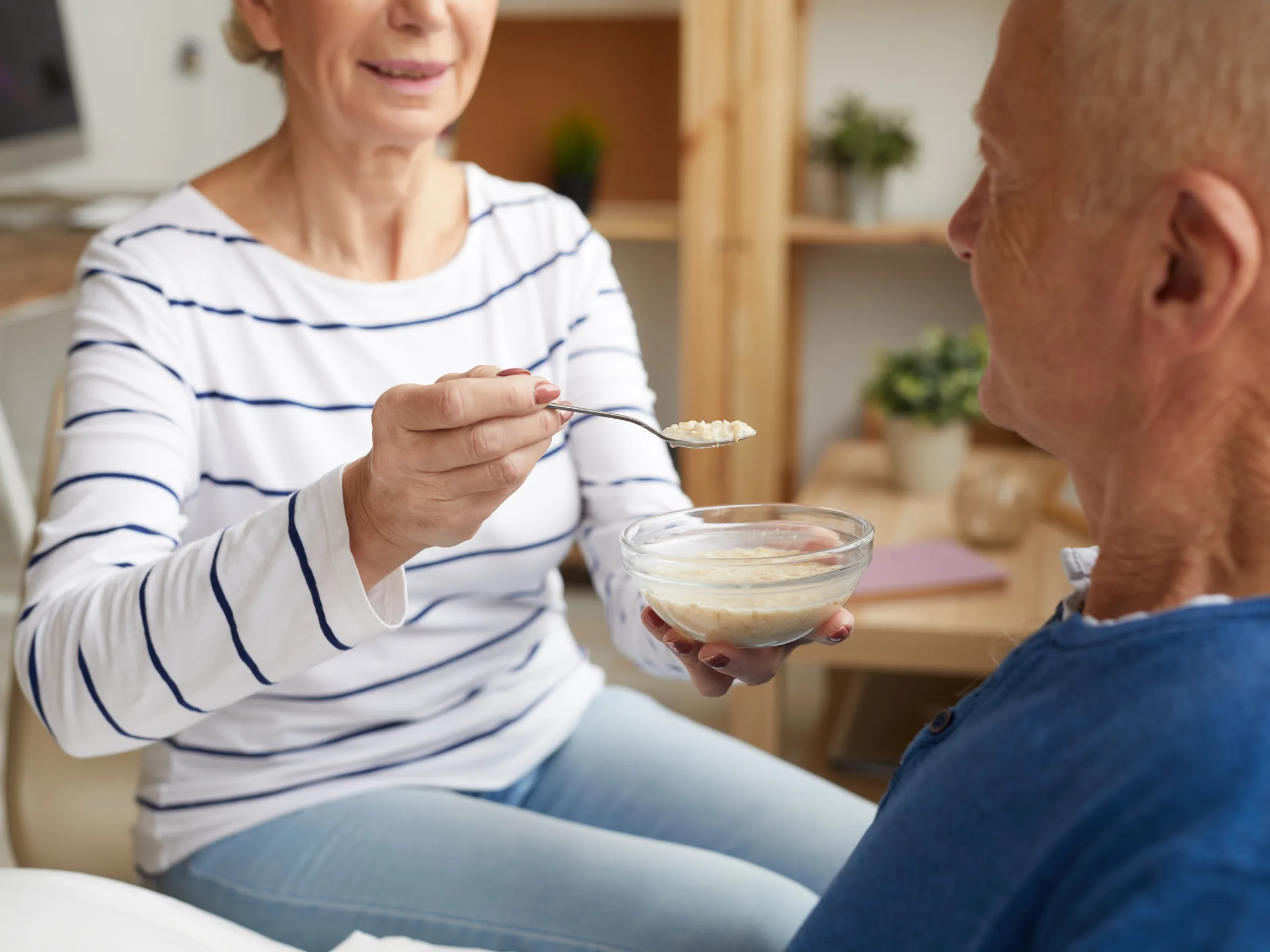 husband and wife eating bowl of granola for breakfast together