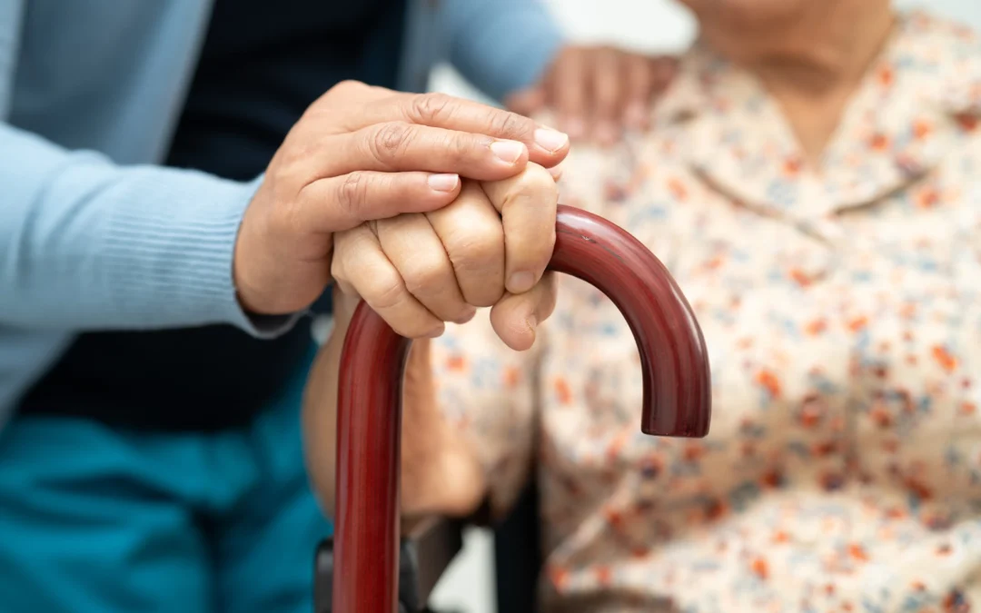 Hip Replacement: Post Surgery Care - woman and elderly woman hand holding a cane